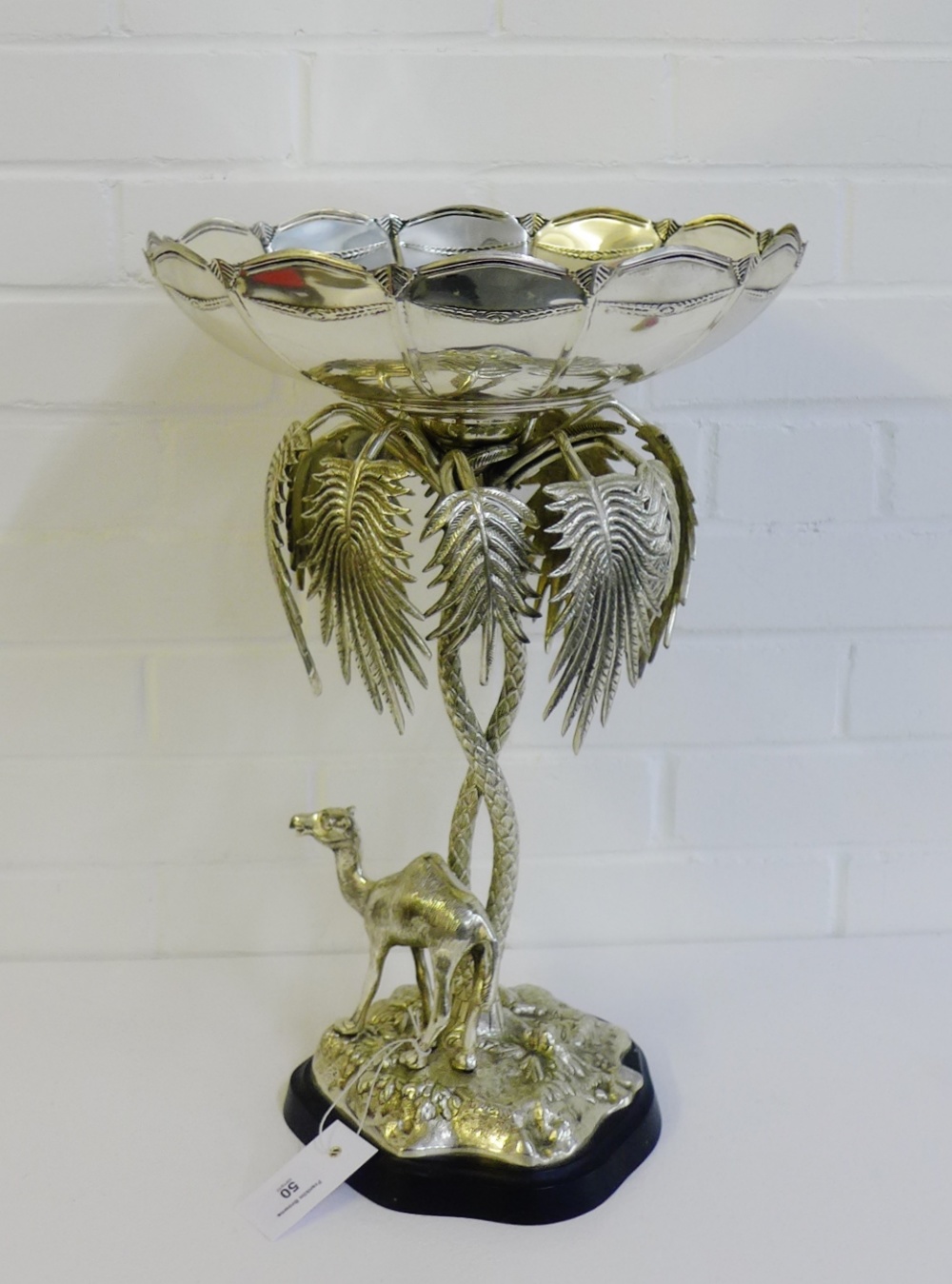 A silver plated table centrepiece with fluted circular comport raised on a palm tree support,