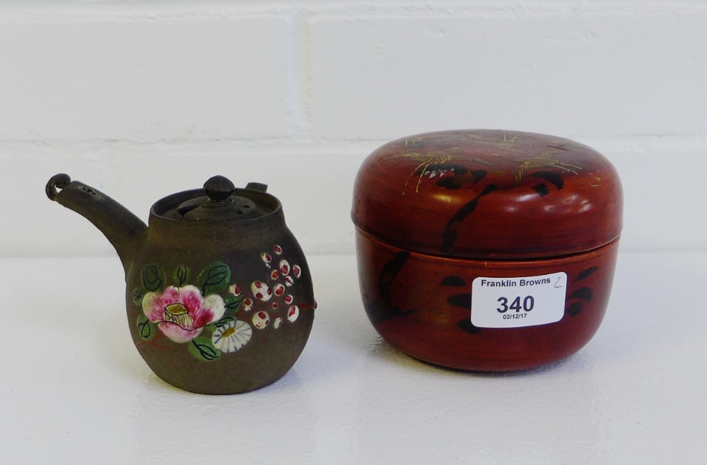 A Japanese lacquered jar and cover decorated with Cranes, together with a brown stoneware saki