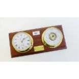 A wall mounted and brass cased clock and barometer plaque, 31cm long