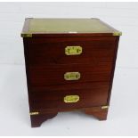 A campaign style three drawer cabinet with leather skivver to top, 58 x 50cm