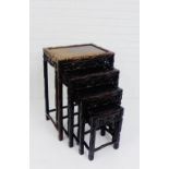 A nest of four Chinese dark wood tables, with leaf carved frieze, 70 x 50cm