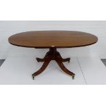 A mahogany oval topped pedestal dining table, 72 x 168cm