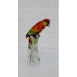 A gold anchor porcelain parrot, modelled perched upon a tree stump, 22cm high