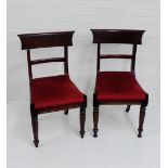A pair of 19th century mahogany blade back chairs with upholstered seats and turned front