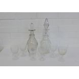 A pair of clear glass decanters, one with original stopper the other with a replacement, together