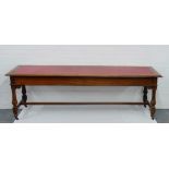 A long oak hall table with inset red leather top, 68 x 242cm