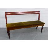 A 19th century mahogany framed hall bench with green plush upholstered seat on turned and tapering