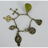 An Iona charm bracelet with a silver and white metal charms to include a cross by Iain MacCormick,