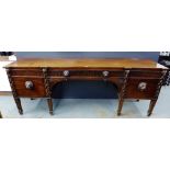 A large 19th century mahogany sideboard in the style of Thomas Hope, the rectangular top over