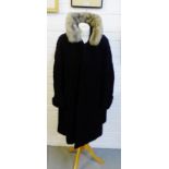 A black Astrakhan coat with a fur collar