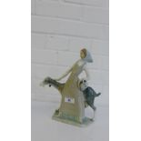 A Lladro porcelain figure of a girl and a goat, 28cm high