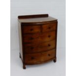 A mahogany chest, the rectangular bow front top over two short and three long drawers, on bracket