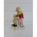 A Staffordshire figure of a woman seated with a jug of ale on a square gilt lined base, 16cm high