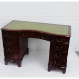 A mahogany pedestal desk with green leather top, 77 x 122cm