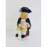 A Staffordshire Toby Jug typically modelled as a seated gent in frock coat and tricorn hat,