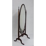 A mahogany cheval mirror, the oval plate flanked by urn finials, 175cm