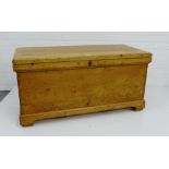 A vintage pine storage trunk with hinged lift up top and bracket plinth base, 52 x 104cm