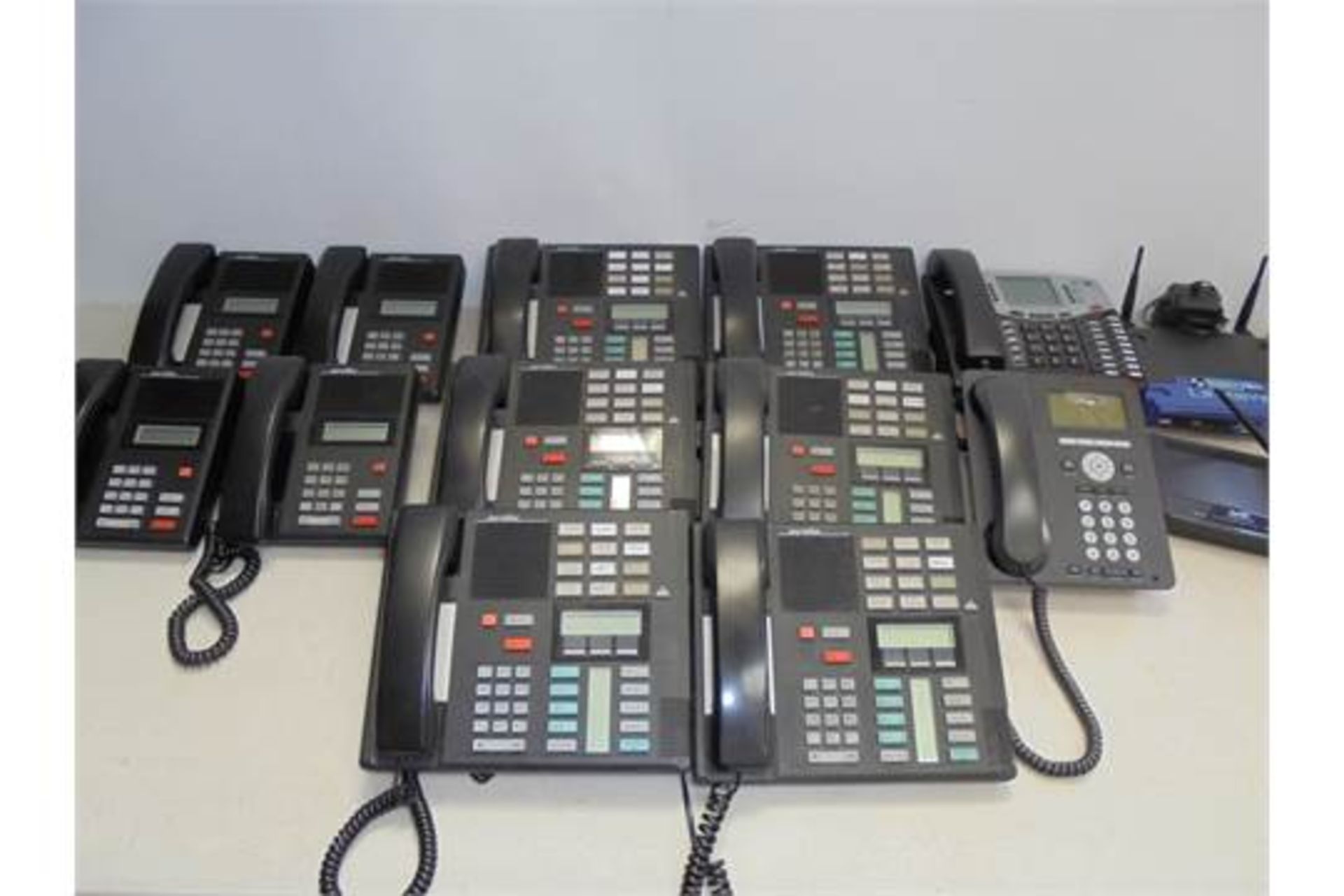 12 Telephone Handsets & 3 Routers to Include; 6 x Meridain M7310, 4 x Meridian M7100, 1 x BT 8662E ,