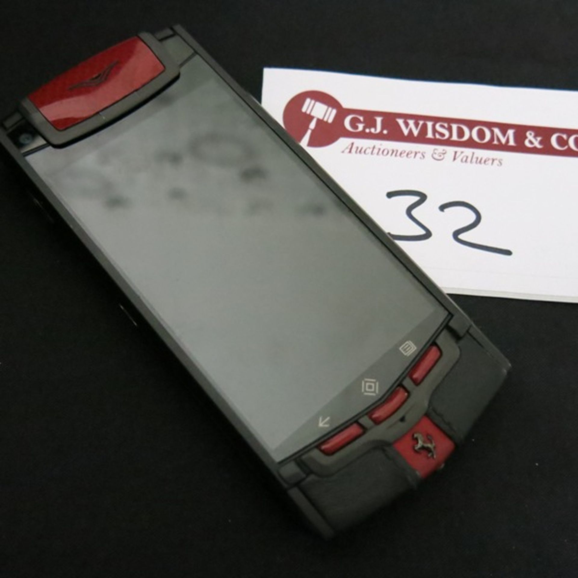 Vertu Ti Ferrari Limited Edition Titanium Phone with Prancing Horse Emblem. Furnished in Red & Black