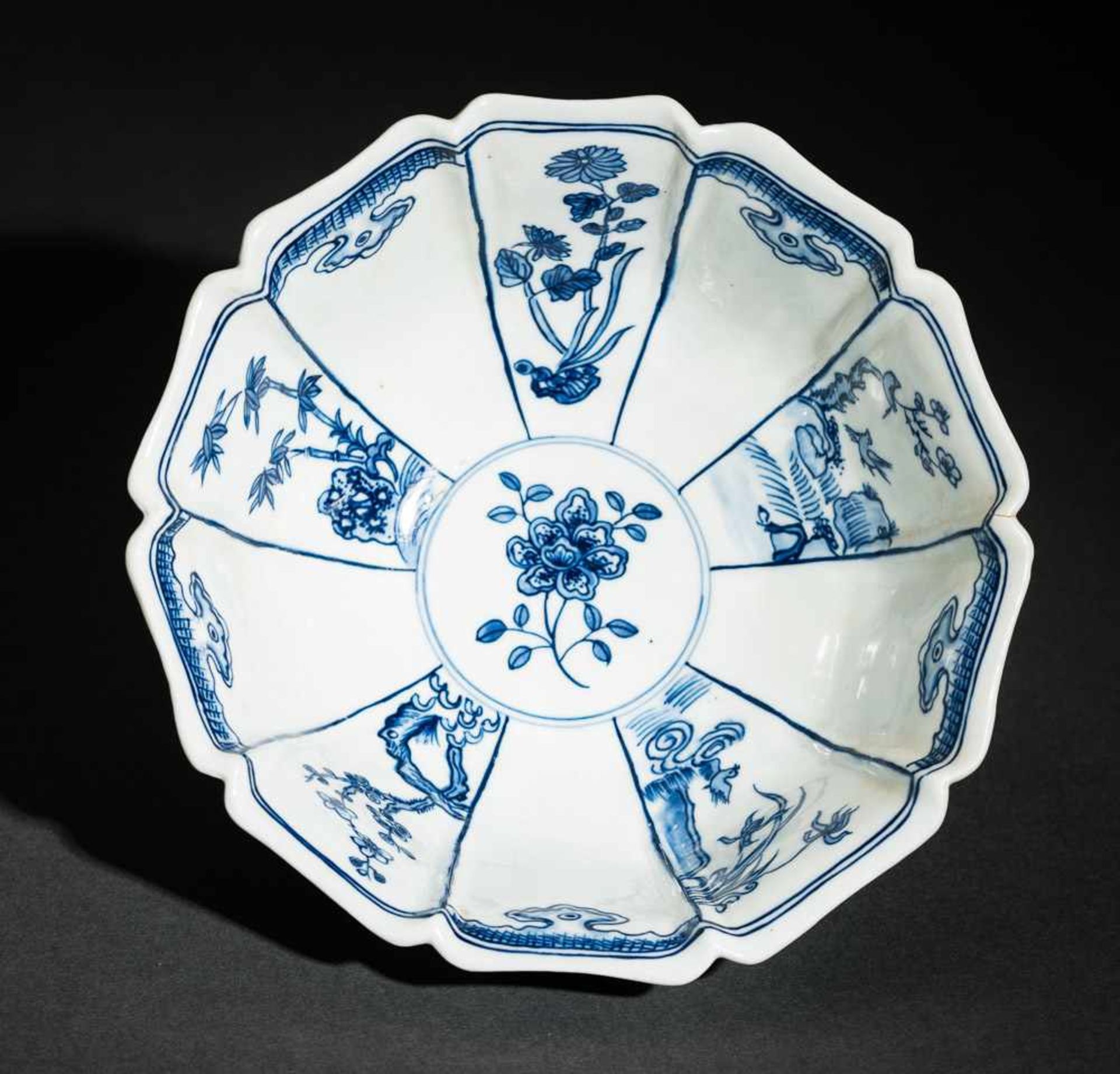 TIEFE SCHALE MIT FIGUREN UND BLÜTEN Blauweißes Porzellan. China, Zehnfach gelappte tiefe Schale, die