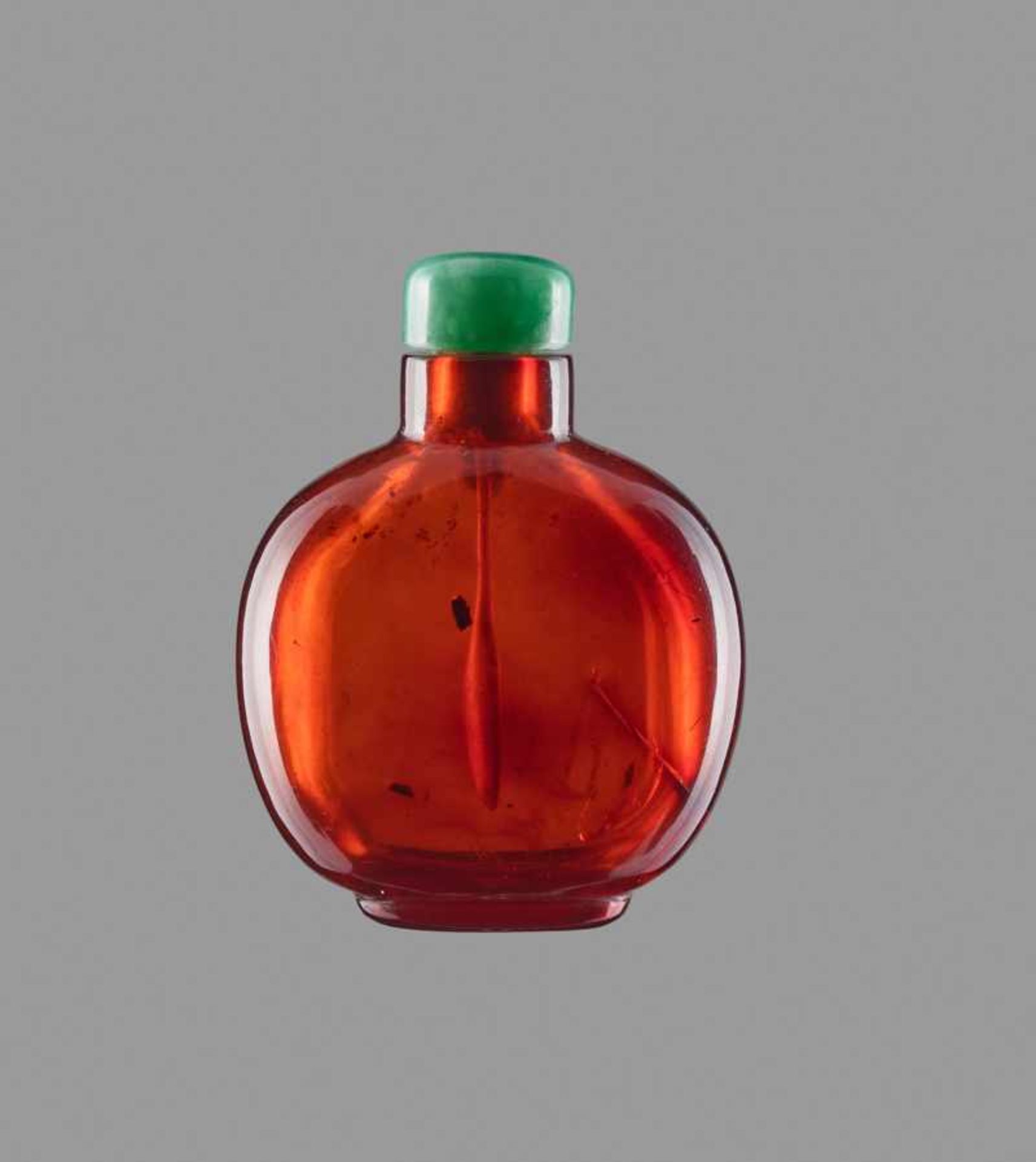 A SMALL PLAIN AMBER SNUFF BOTTLE Transparent amber of even golden-brown color, with a few smaller