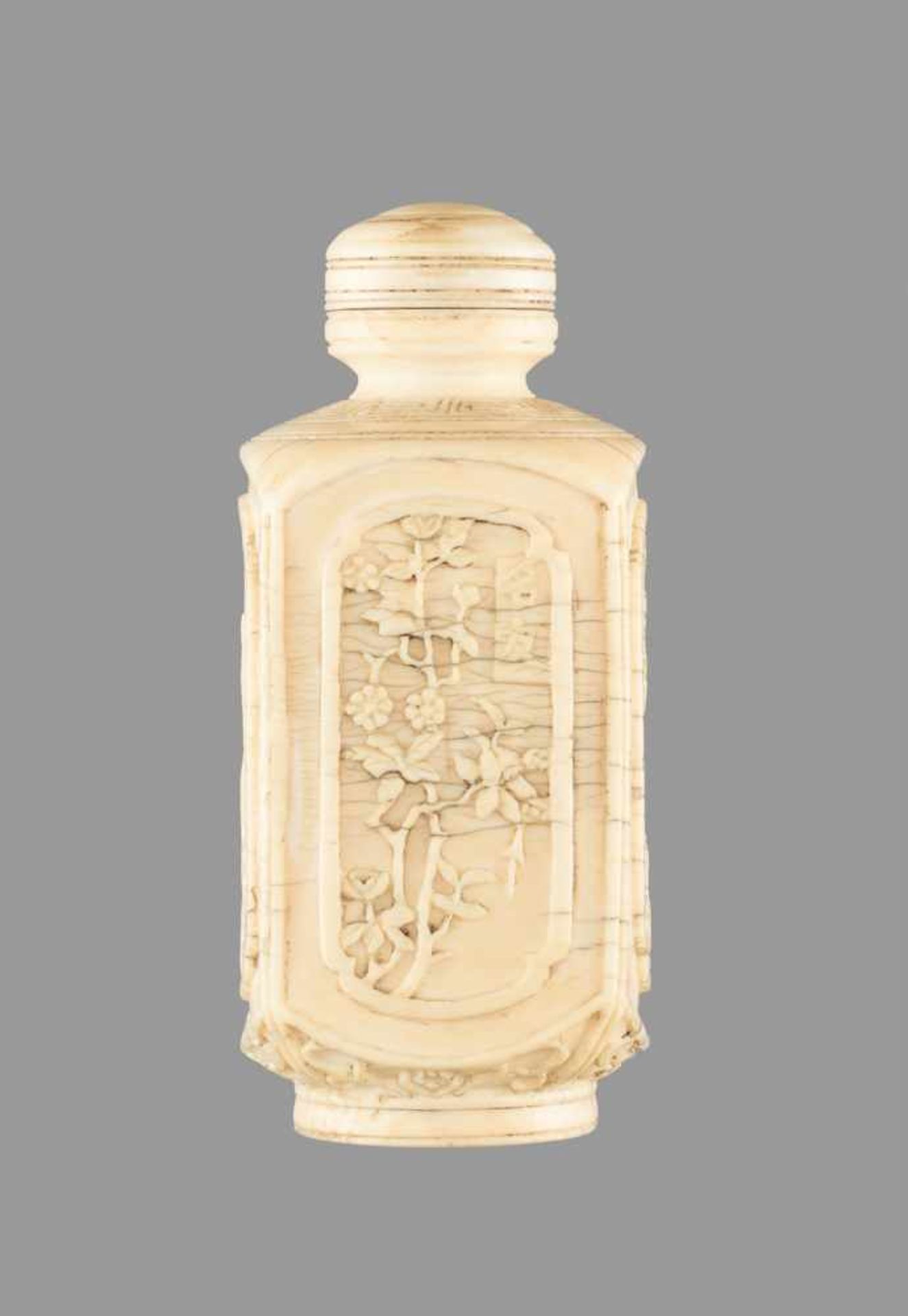 A CARVED IVORY 'TEN FRIENDS AMONG FLOWERS' SNUFF BOTTLE, 19TH CENTURY Ivory with age crazing, even