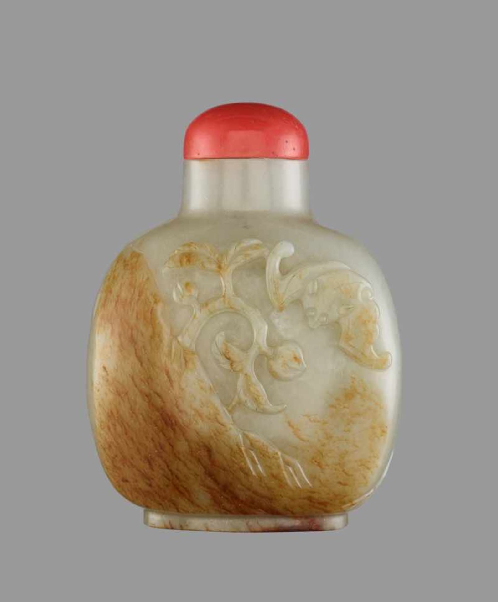 A WHITE AND RUSSET JADE ‘BAT AND PEACHES’ SNUFF BOTTLE Nephrite of even celadon color with a layer