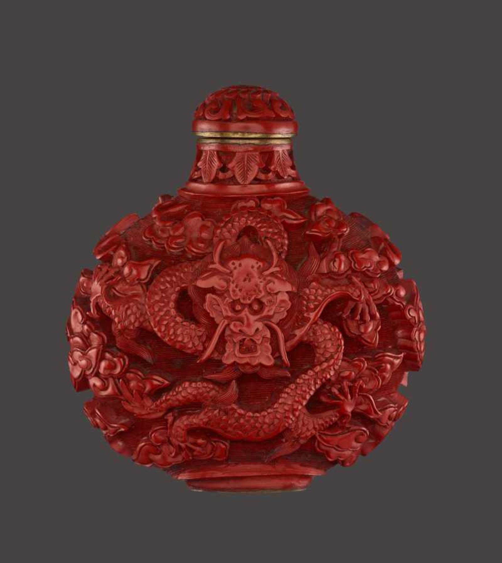 A CINNABAR LACQUER ‘DRAGON’ SNUFF BOTTLE Cinnabar lacquer in high relief on bronze body. China, late