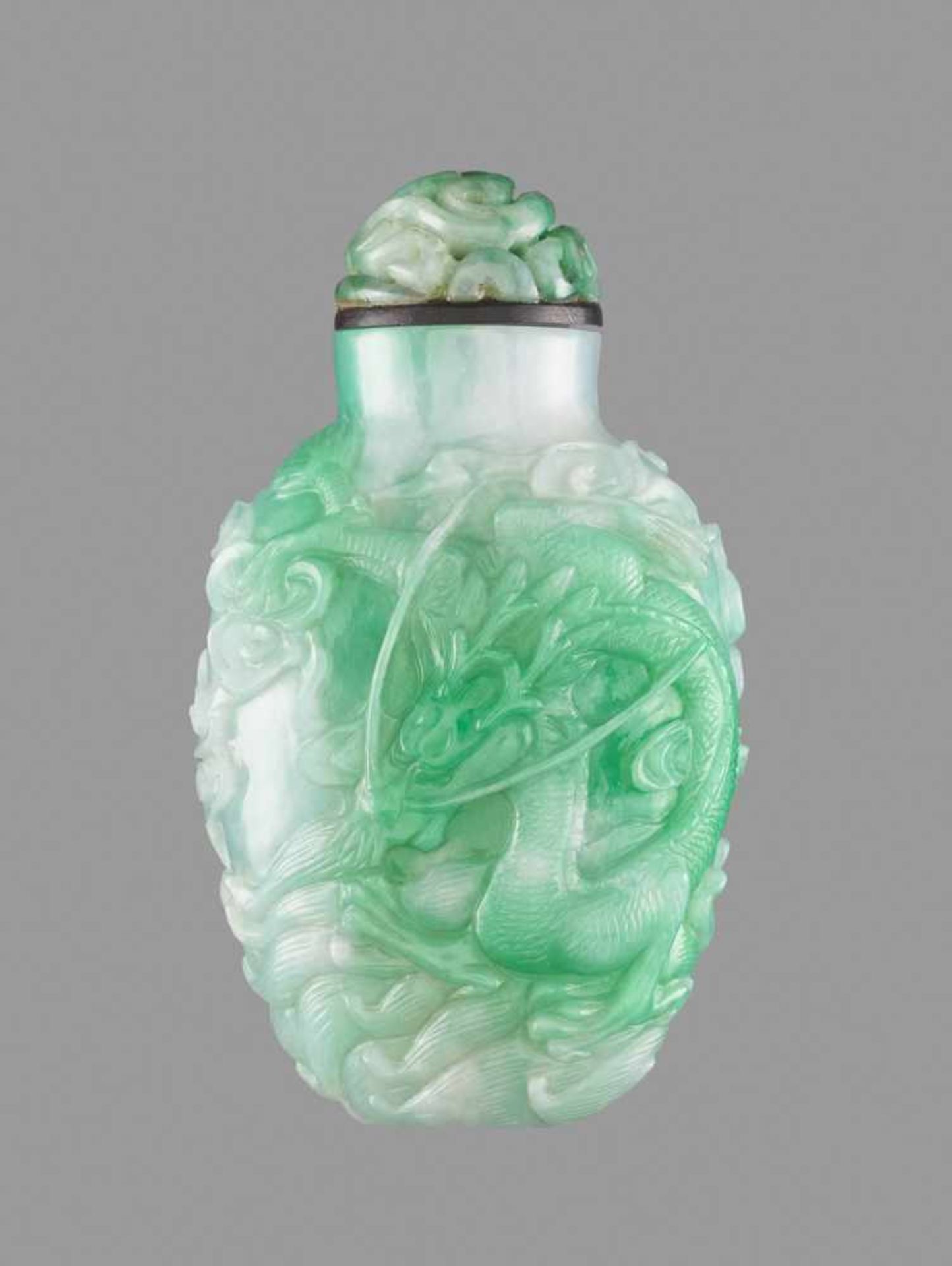 AN EMERALD GREEN JADEITE 'DRAGON' SNUFF BOTTLE, QING DYNASTY Lustrous semi-translucent jadeite of