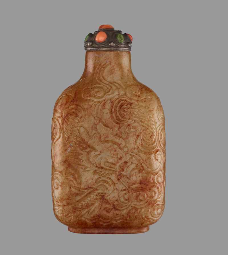 A CELADON AND RUSSET JADE ‘DRAGON’ SNUFF BOTTLE Nephrite with dense streaks of russet, the