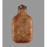 A CELADON AND RUSSET JADE ‘DRAGON’ SNUFF BOTTLE Nephrite with dense streaks of russet, the