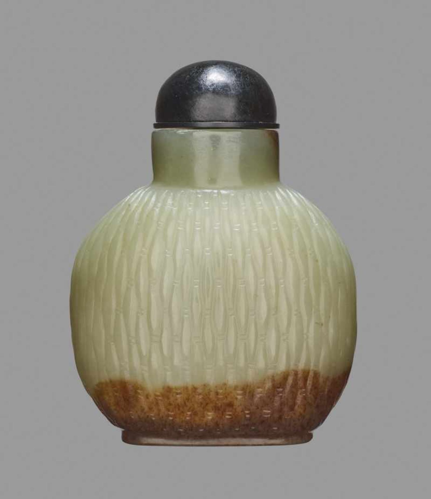 A CELADON AND RUSSET JADE 'BASKET-WEAVE' SNUFF BOTTLE Nephrite, of even celadon color with dark