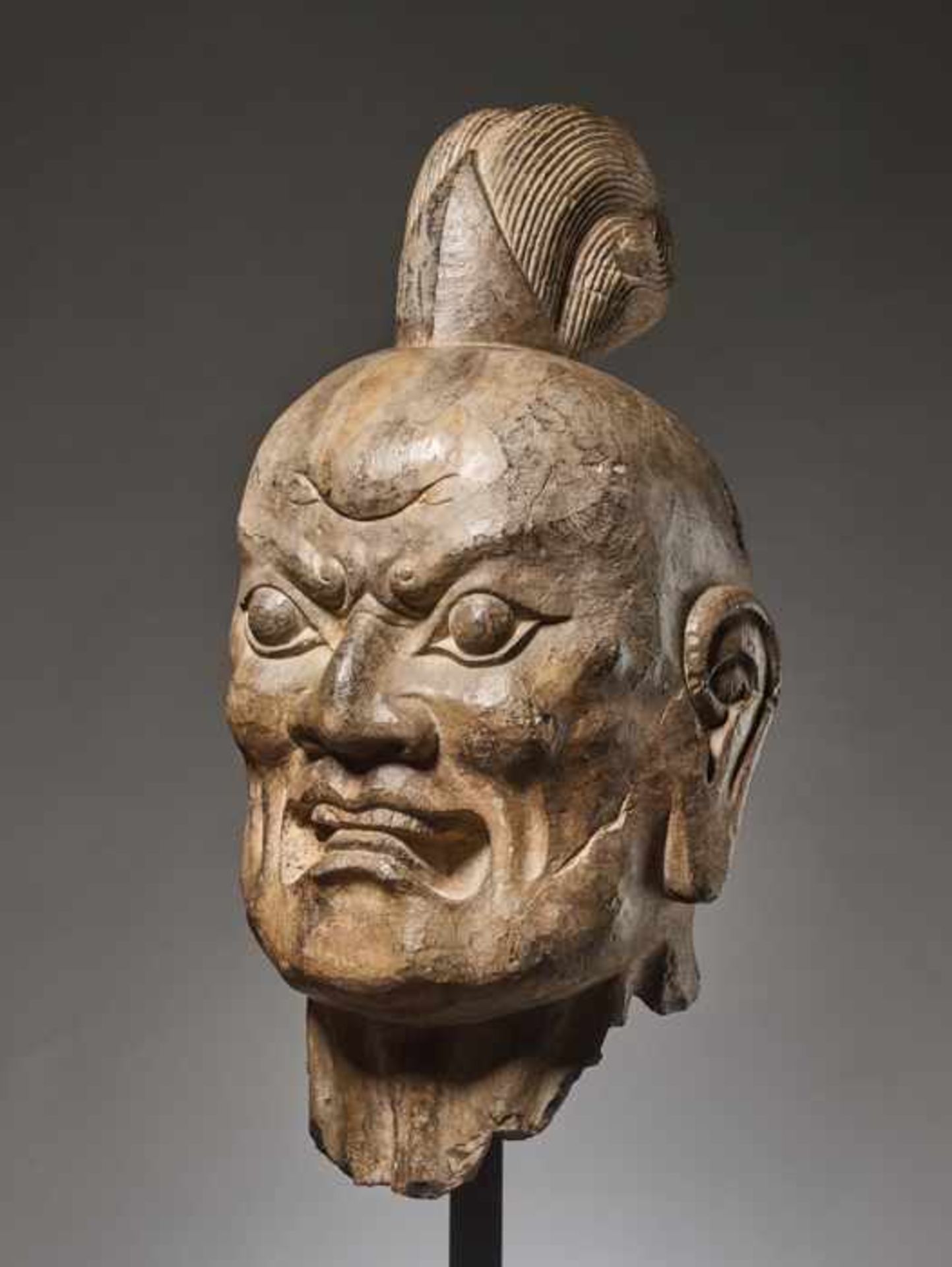 OVER-LIFESIZE LIMESTONE HEAD OF A TIANWANG GUARDIAN GOD, CHINA, TANG DYNASTY Sculpted and carved