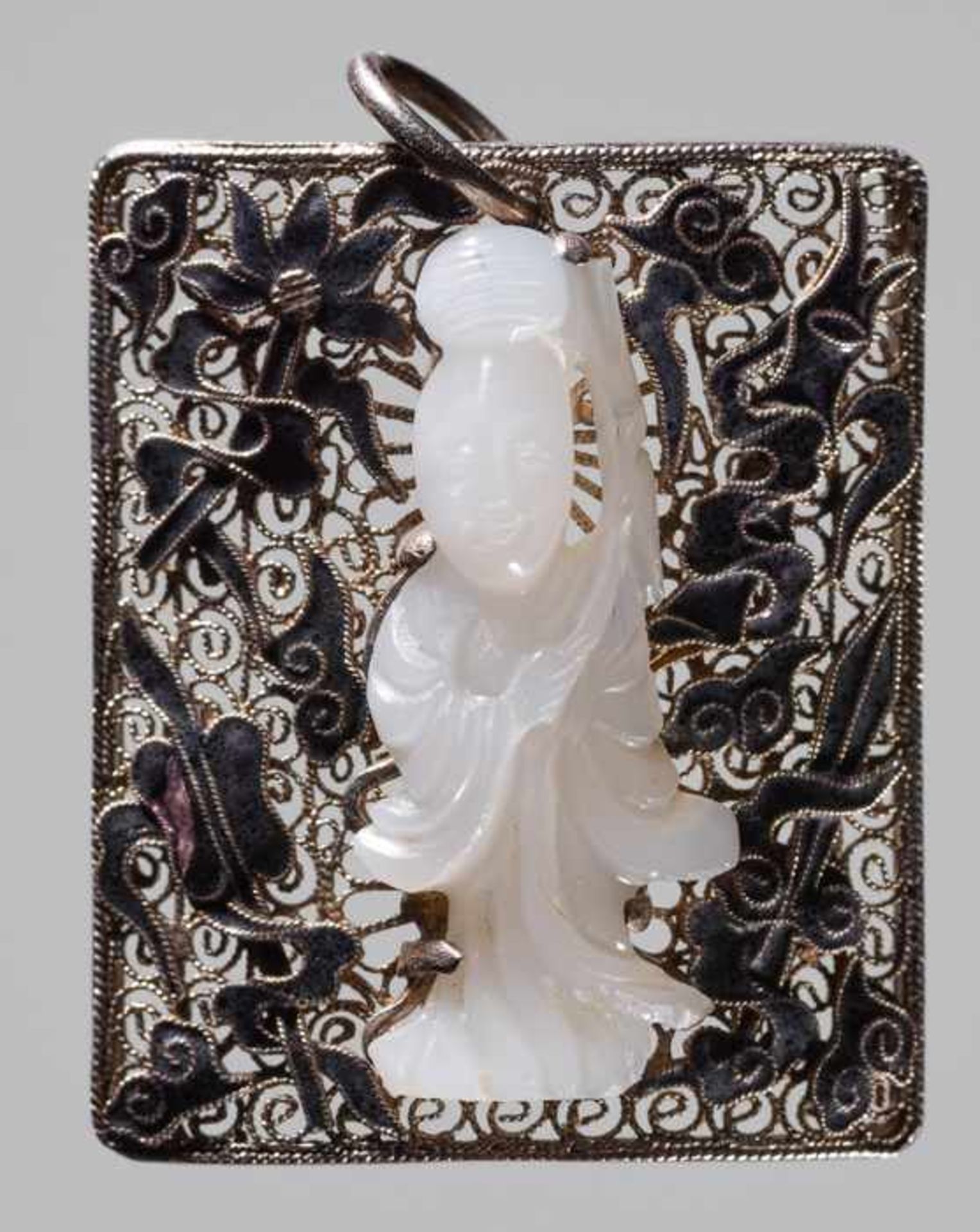 AN ENAMELED SILVER PENDANT WITH A WHITE JADE GUANYIN, LATE QING OR REPUBLIC Silver with black