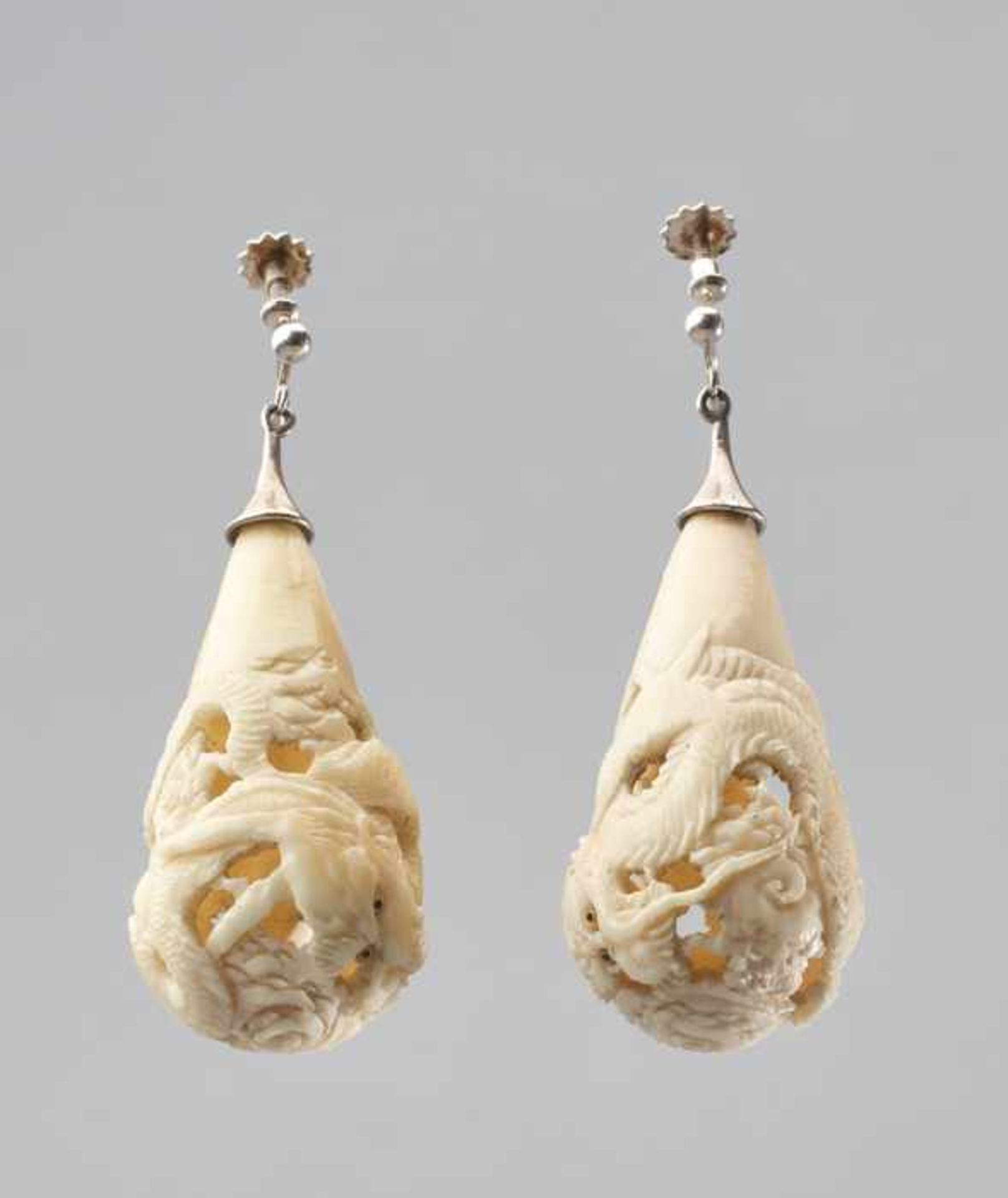 A PAIR OF CARVED IVORY DRAGON EARRINGS, 1920s Ivory with mother of pearl inlaid eyes, worked in