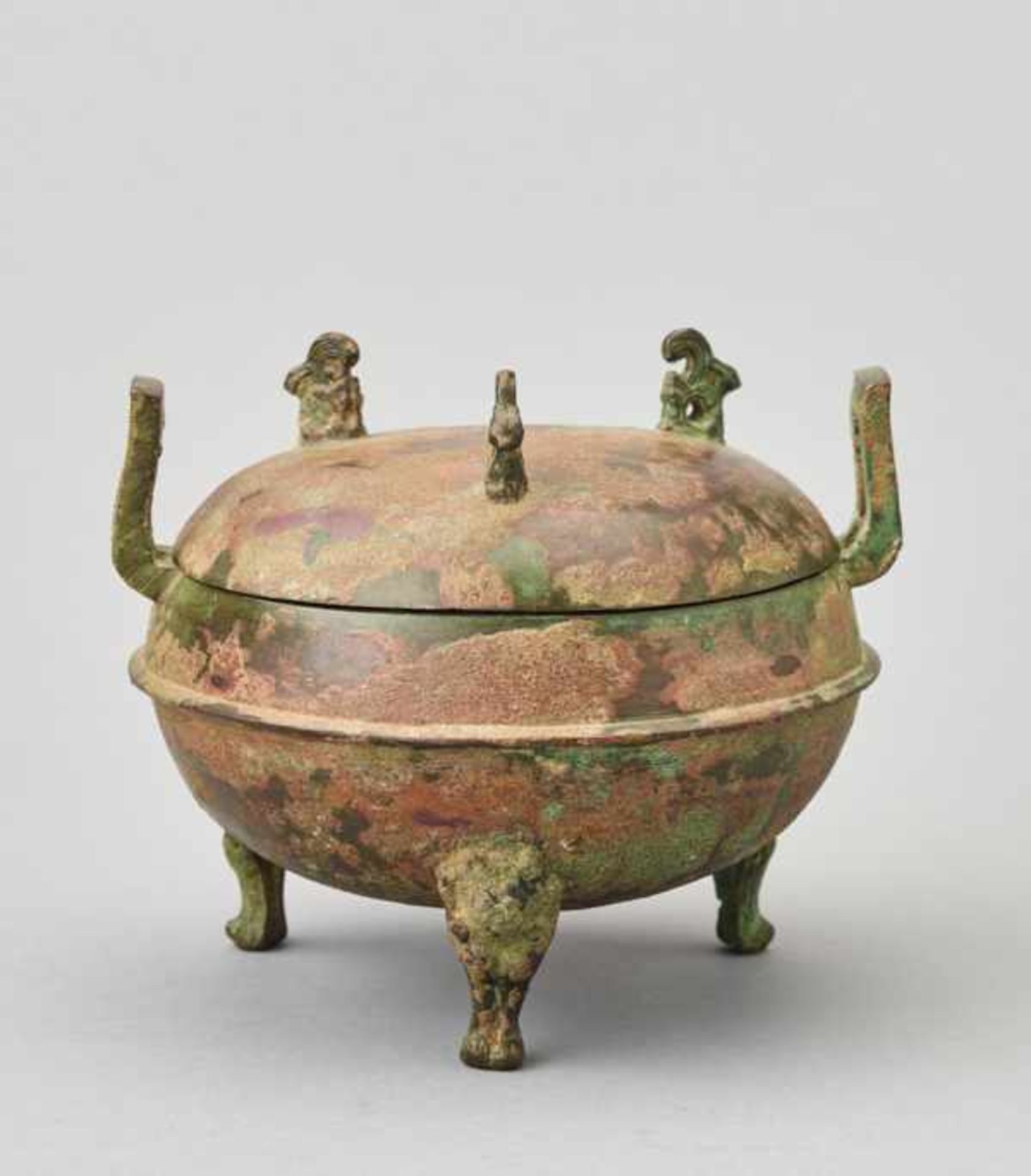 A ‘MYTHICAL ANIMALS AND BIRDS’ BRONZE RITUAL VESSEL AND COVER, DING, HAN DYNASTY Cast bronze of