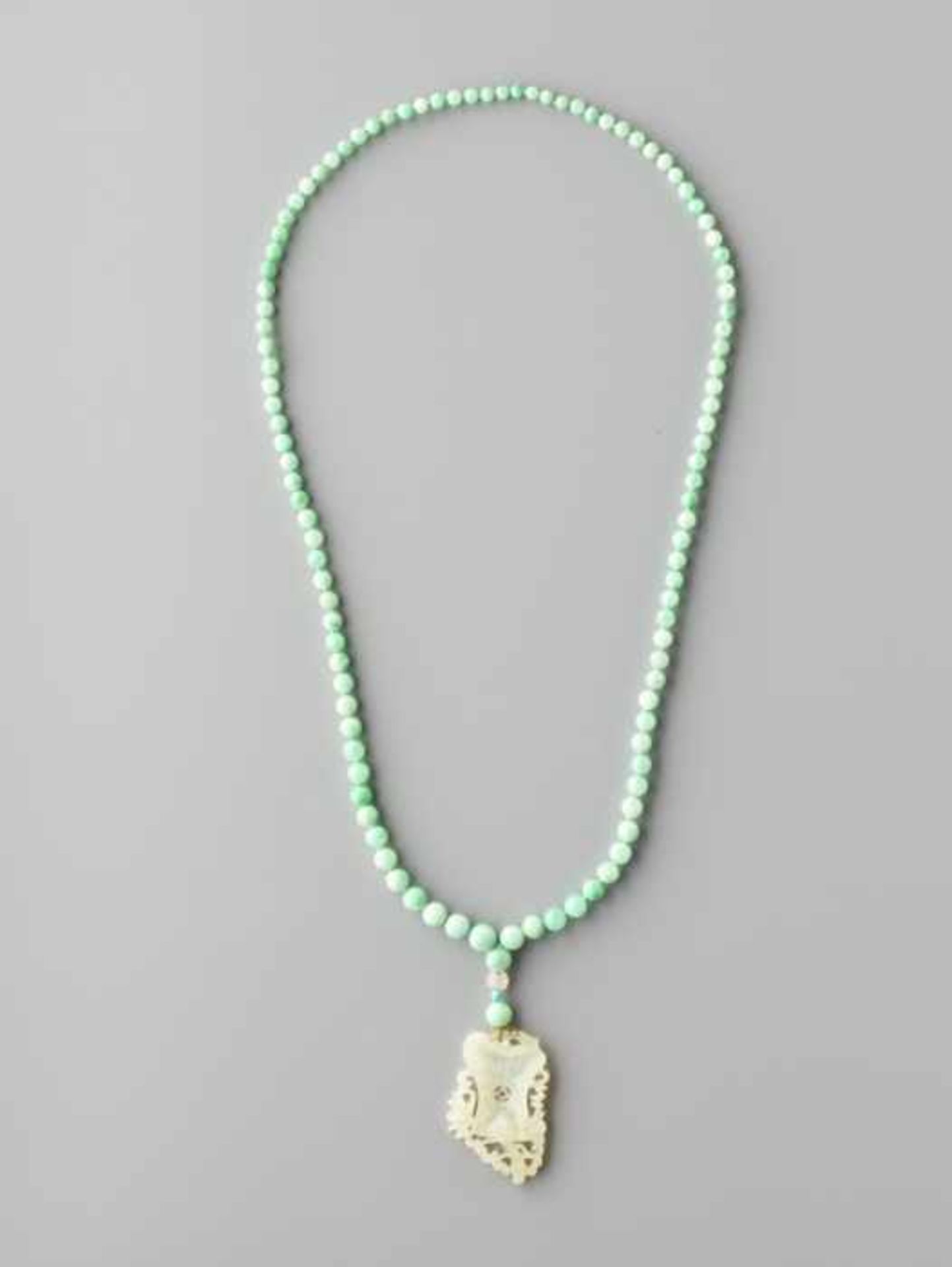 AN APPLE GREEN JADEITE NECKLACE, 108 BEADS, SUPPORTING A WHITE JADE PENDANT Natural apple green