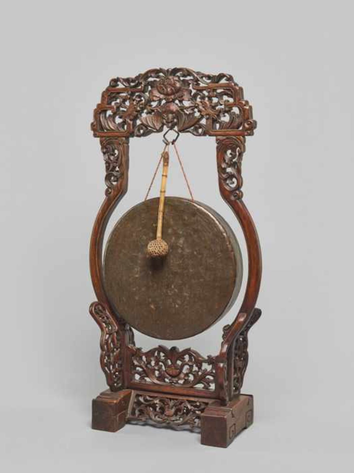 A BRONZE TEMPLE GONG WITH CARVED WOODEN FRAME, QING DYNASTY Carved brown wood, bronze, bamboo,