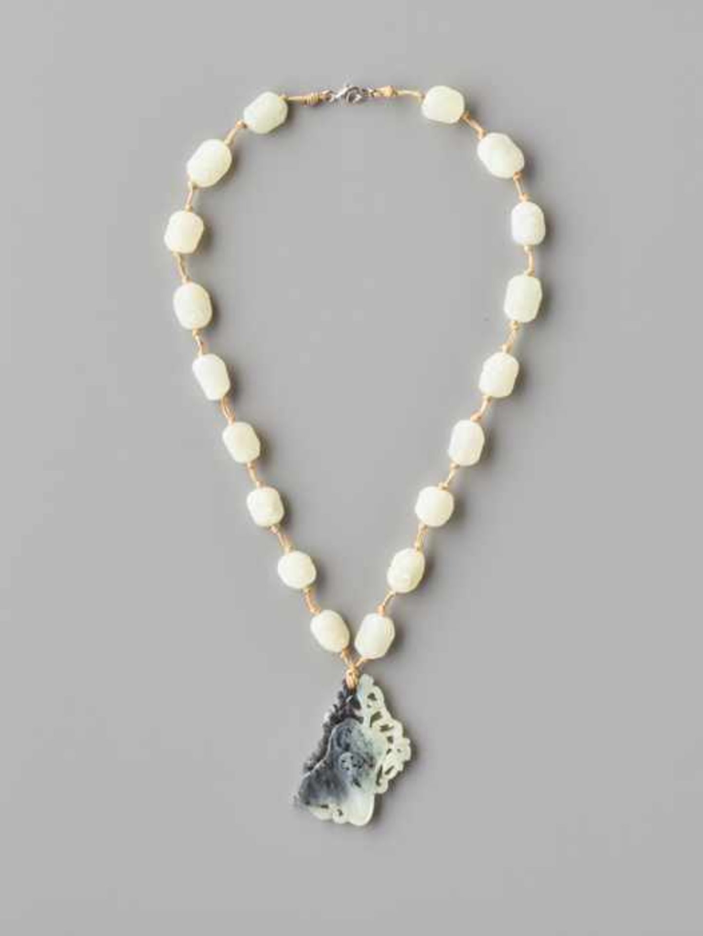 A WHITE JADE 'EIGHTTEEN ARHATS' ROSARY, QING DYNASTY The beads of nephrite with flawless white color