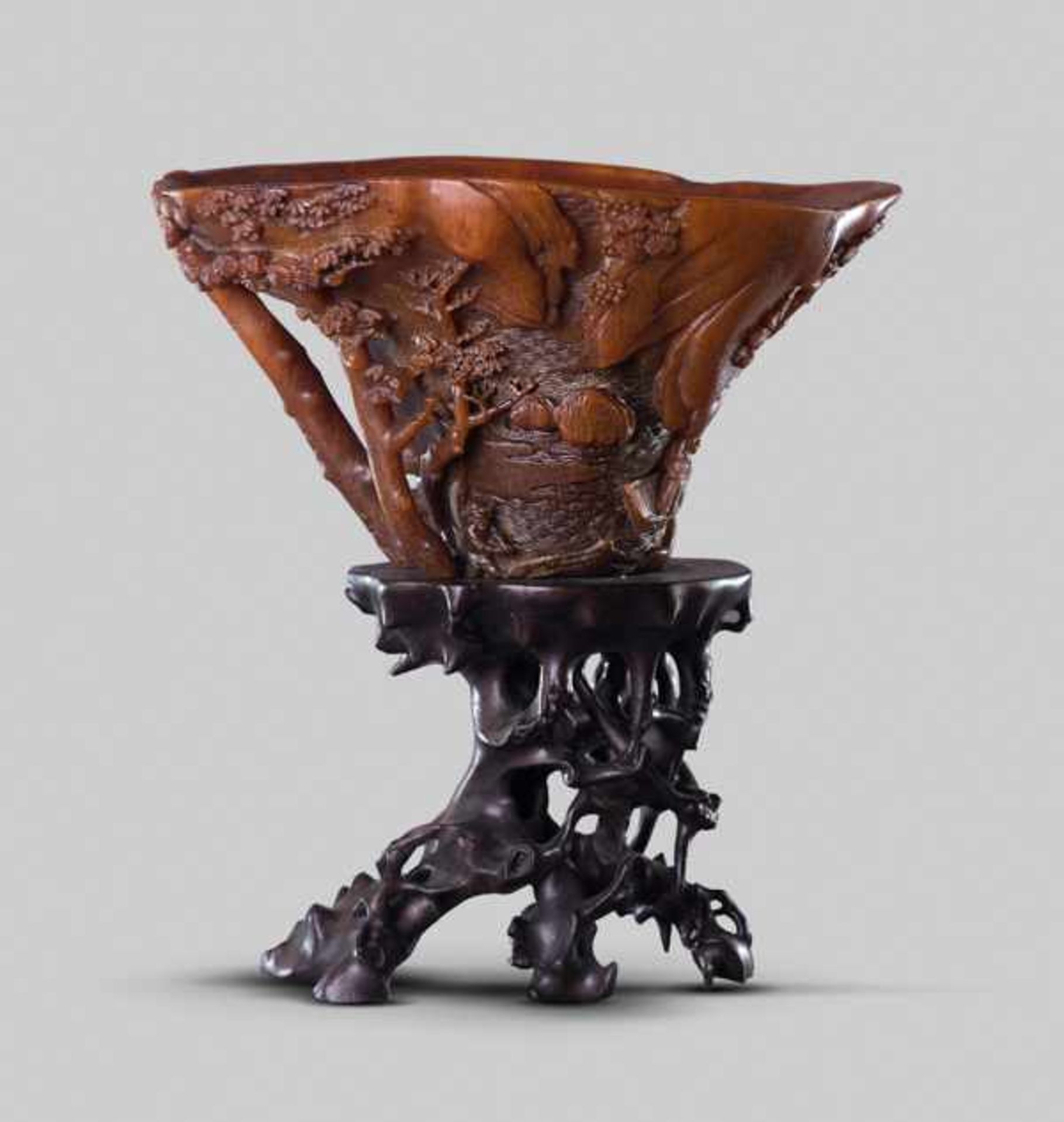 A SIGNED RHINOCEROS HORN 'LANDSCAPE' LIBATION CUP, SCHOOL OF ZHOU WENSHU, 17TH CENTURY The horn of