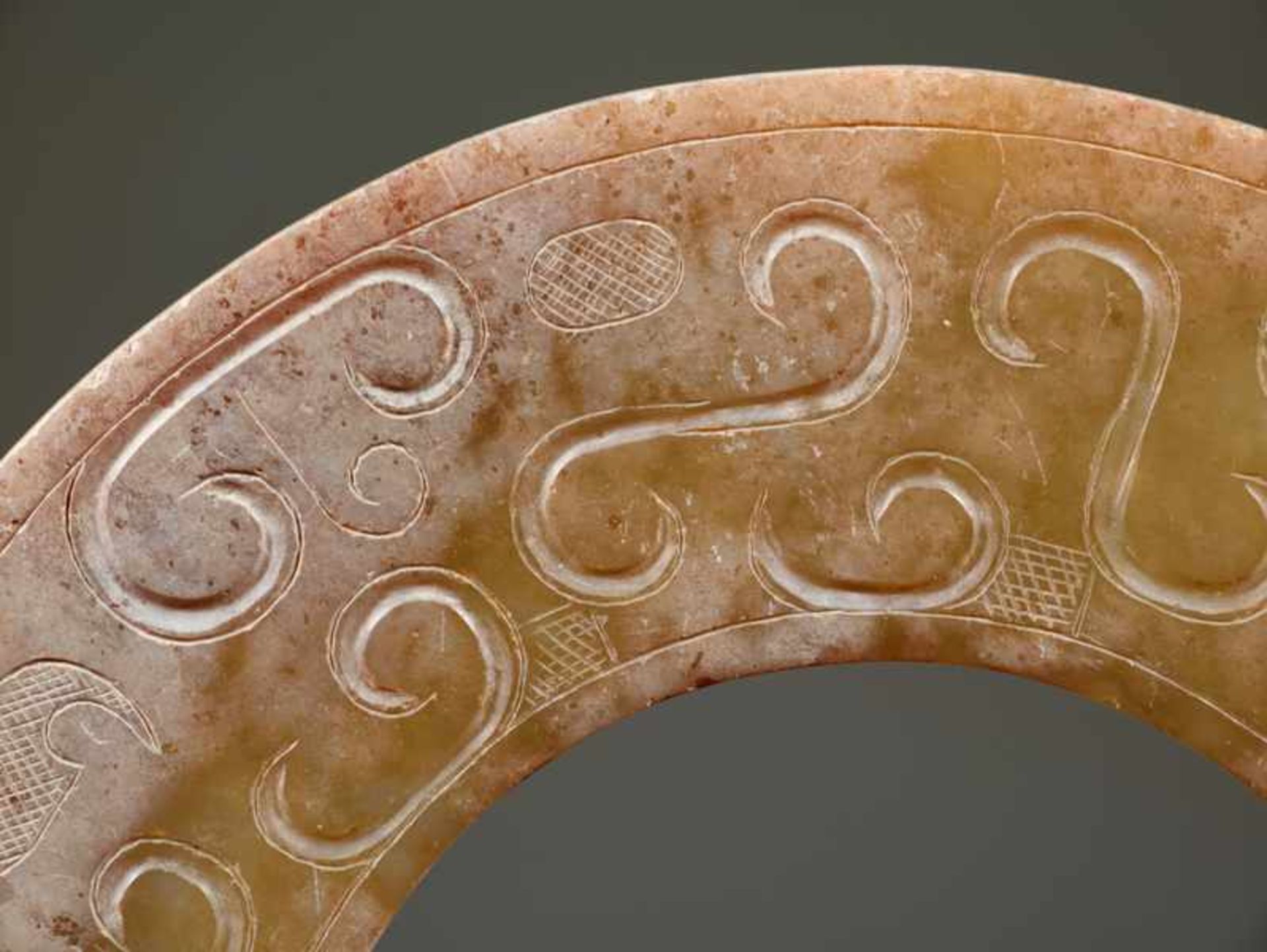 A REFINED HUAN RING WITH SUBTLY CARVED ABSTRACT-LOOKING DRAGON HEADS Jade. China, Eastern Zhou, - Image 4 of 11