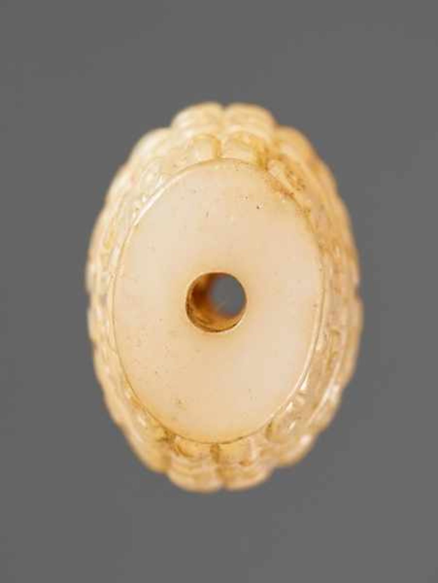 A SUPERB BARREL-SHAPED BEAD IN WHITE JADE WITH MASK MOTIFS AND CURLS IN RELIEF Jade. China, - Image 3 of 6