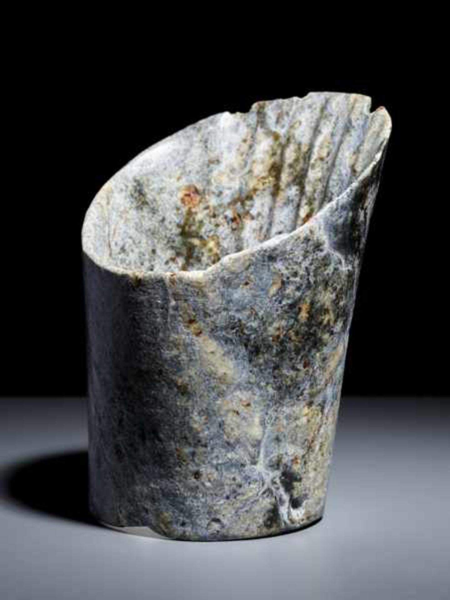 A REMARKABLE NEOLITHIC HOOF-SHAPED (TIXING) SLANTED TUBE IN STRONGLY WEATHERED JADE Jade. China,