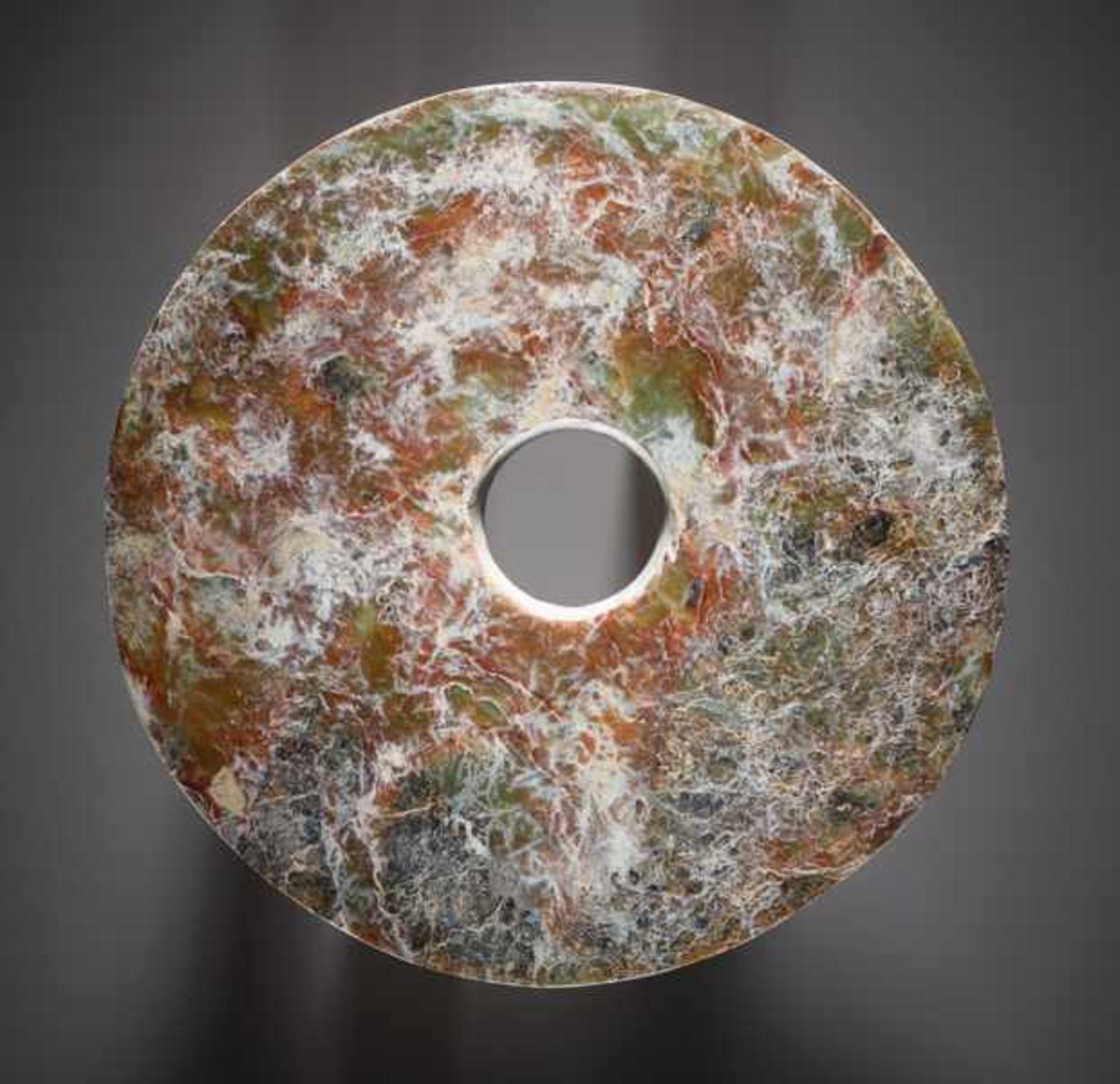 AN IMPOSING BI DISC WITH A FINE-TEXTURED SURFACE AND MIRROR-LIKE POLISH Jade. China, Late Neolithic,