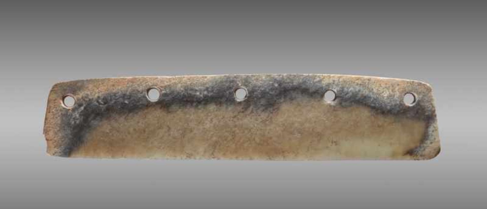 A DAO, OR KNIFE-SHAPED BLADE, WITH FIVE FASTENING HOLES, CARVED FROM A MULTI-COLOURED JADE WITH A