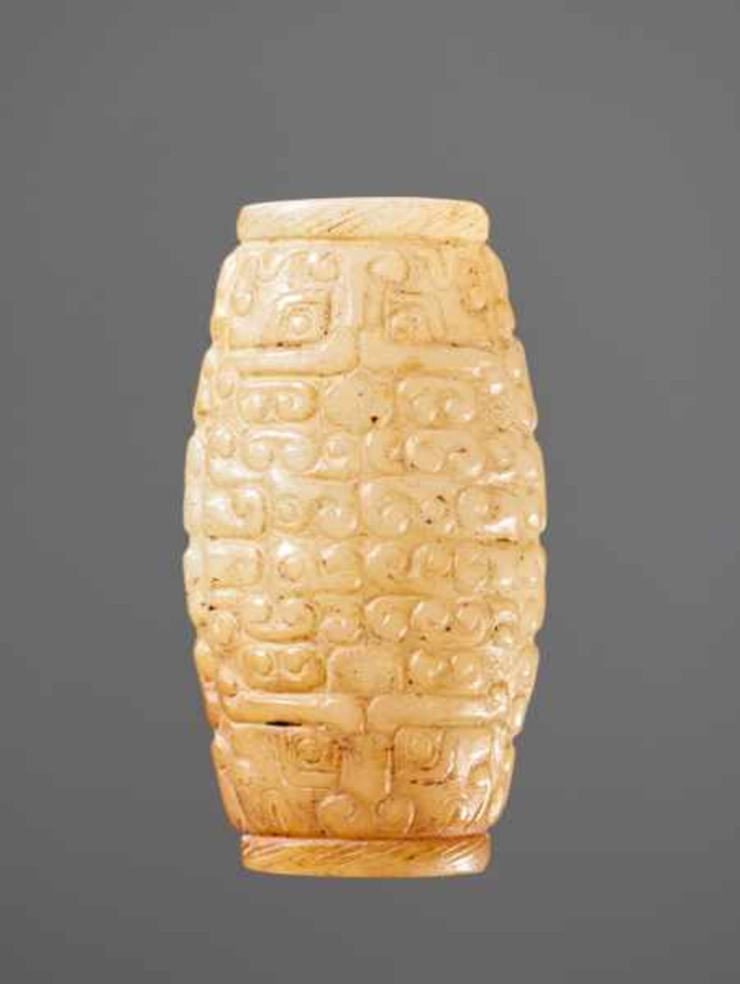 A SUPERB BARREL-SHAPED BEAD IN WHITE JADE WITH MASK MOTIFS AND CURLS IN RELIEF Jade. China, - Image 2 of 6