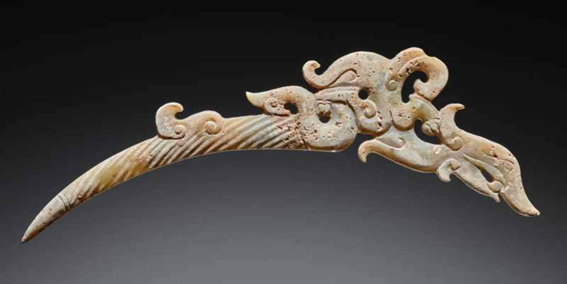 A UNIQUE ELEGANT AND DELICATELY CARVED DRAGON-SHAPED XI OR “KNOT-OPENER” Jade. China, EASTERN