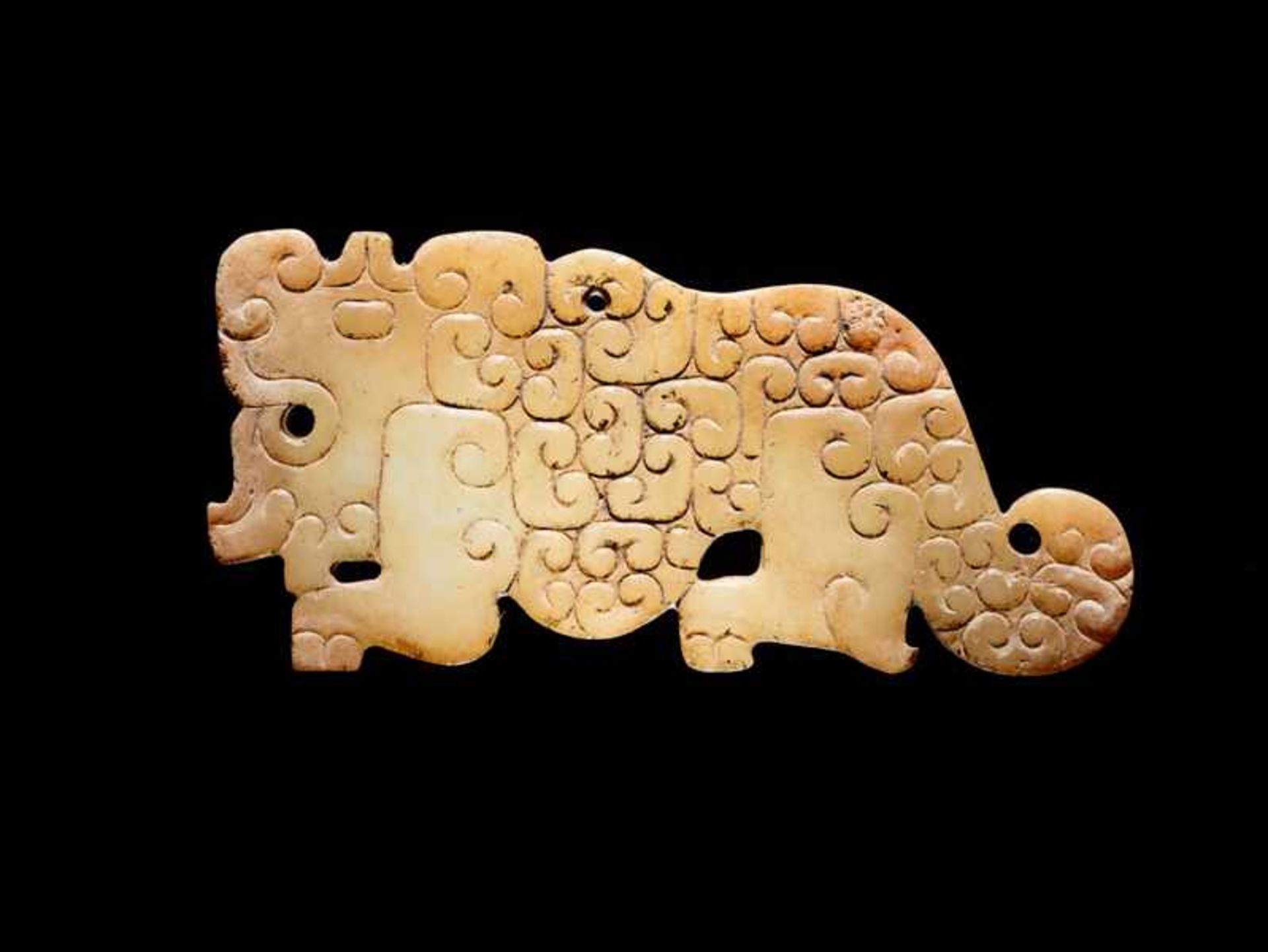 A SMALL, FLAT TIGER-SHAPED PENDANT IN WHITE JADE DECORATED WITH A JUANYUN PATTERN OF SCROLLS Jade.