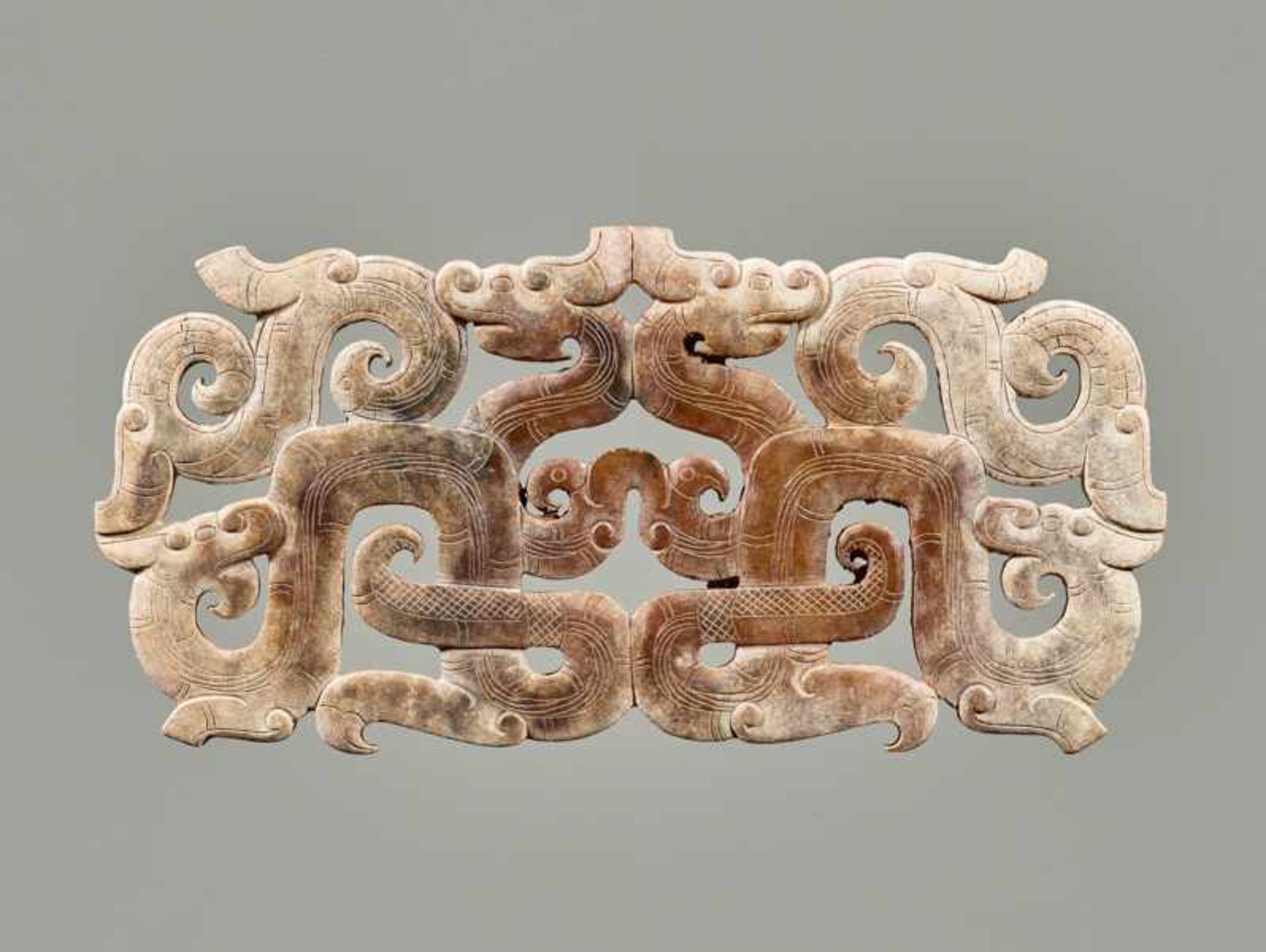 AN EXCEPTIONAL OPENWORK ORNAMENT WITH AN INTRICATE DESIGN OF DRAGONS AND BIRDS Jade. China,