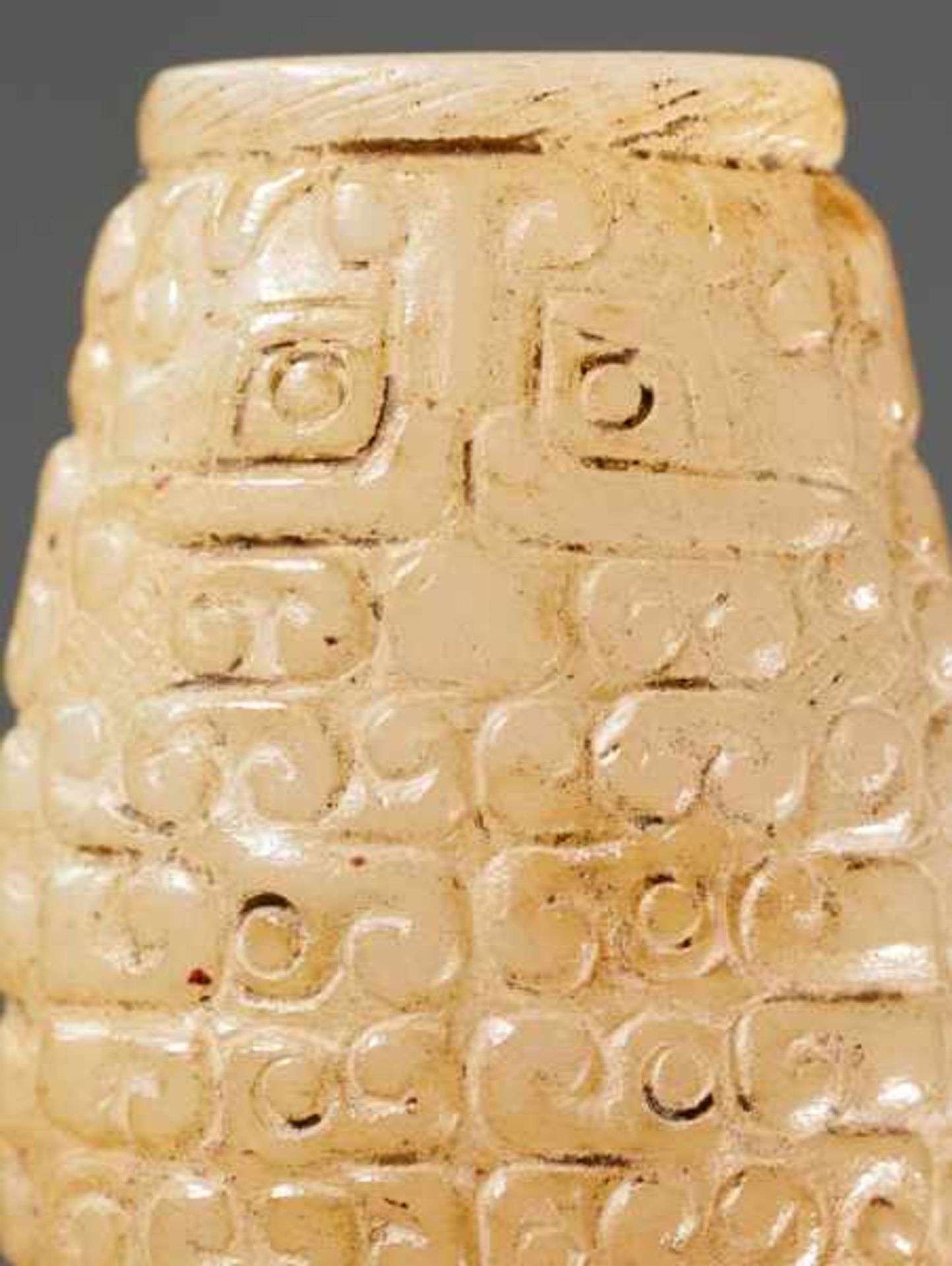 A SUPERB BARREL-SHAPED BEAD IN WHITE JADE WITH MASK MOTIFS AND CURLS IN RELIEF Jade. China, - Image 6 of 6